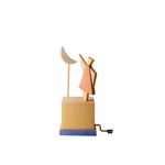 Wooden hand-cranked music box depicting a young girl with a crescent moon on a white background