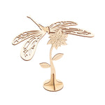 Laser cut wooden dragonfly and flower on a white background