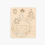 Wooden plate showing laser cut  with Christmas-themed cutouts on a beige background