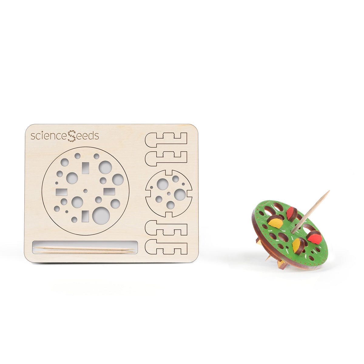 Laser cut model of a toothpick top with a collection of circles reminding one of bubbles  along with a colored top on a white background, branded 'scienceseeds'.