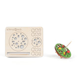 Laser cut model of a toothpick top with a collection of circles reminding one of bubbles  along with a colored top on a white background, branded 'scienceseeds'.