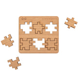 CubeMaster Challenger 3D wooden puzzle with three of  its laser-cut component arranged around the central  board