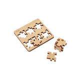 Laser-cut wooden pieces  of the CubeMaster Challenger 3D cube puzzle partly assembled with board in background