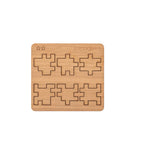 Laser-cut wooden pieces and components of the CubeMaster Challenger 3D cube puzzle laid out flat
