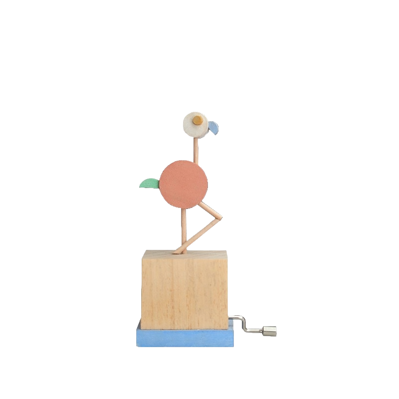 Hand cranked wooden music box with a colorful flamingo on top against a white background