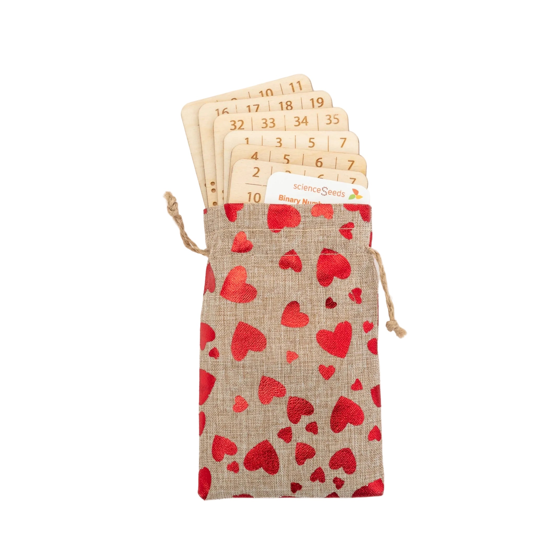A rustic hemp drawstring bag decorated with shiny red hearts, containing a precision laser-cut wooden binary magic card used for a mathematical number-guessing trick.