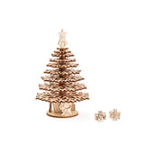 Medium height single laser-cut wooden Christmas tree with tiered snowflake shaped branches, featuring a white star finial topper and miniature  gift box and dog decorations at the base