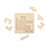 Handmade birch 365-in-one daily calendar challenge shown partially solved with several laser-cut wooden pieces resting around the board