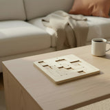 Handmade birch wood perpetual calendar puzzle solved and displayed on a desk with a mug, highlighting its use as a functional STEM desk accessory