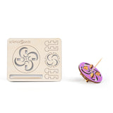 Laser cut model of a toothpick top with a crescent and swirl  pattern along with a colored top on a white background, branded 'scienceseeds'.