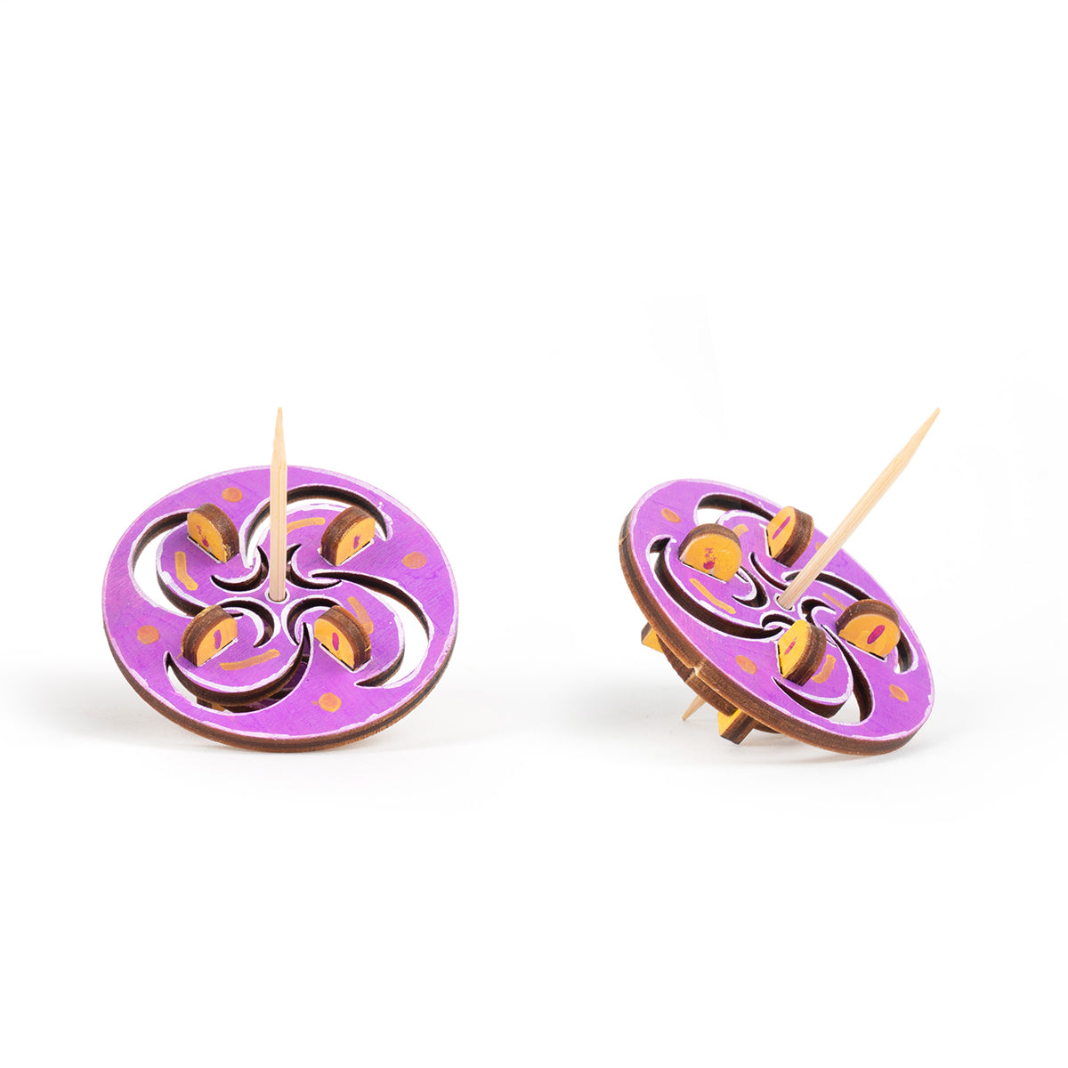 Colored  toothpick tops front and slanted with crescent and swirl motif on a white background