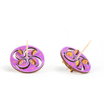 Colored  toothpick tops front and slanted with crescent and swirl motif on a white background