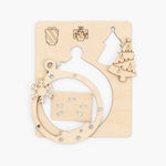 Wooden Christmas ornament with cut-out shapes on a white background