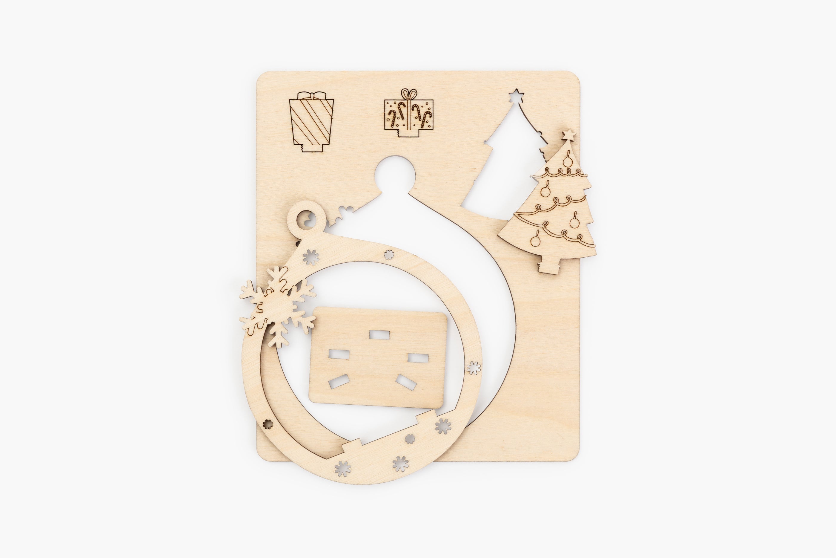 Wooden Christmas ornament with cut-out shapes on a white background